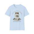 God Is Watching T-Shirt front view: An eye floats inside a Mason jar resting on a lace doily beneath God Is Watching lettering.