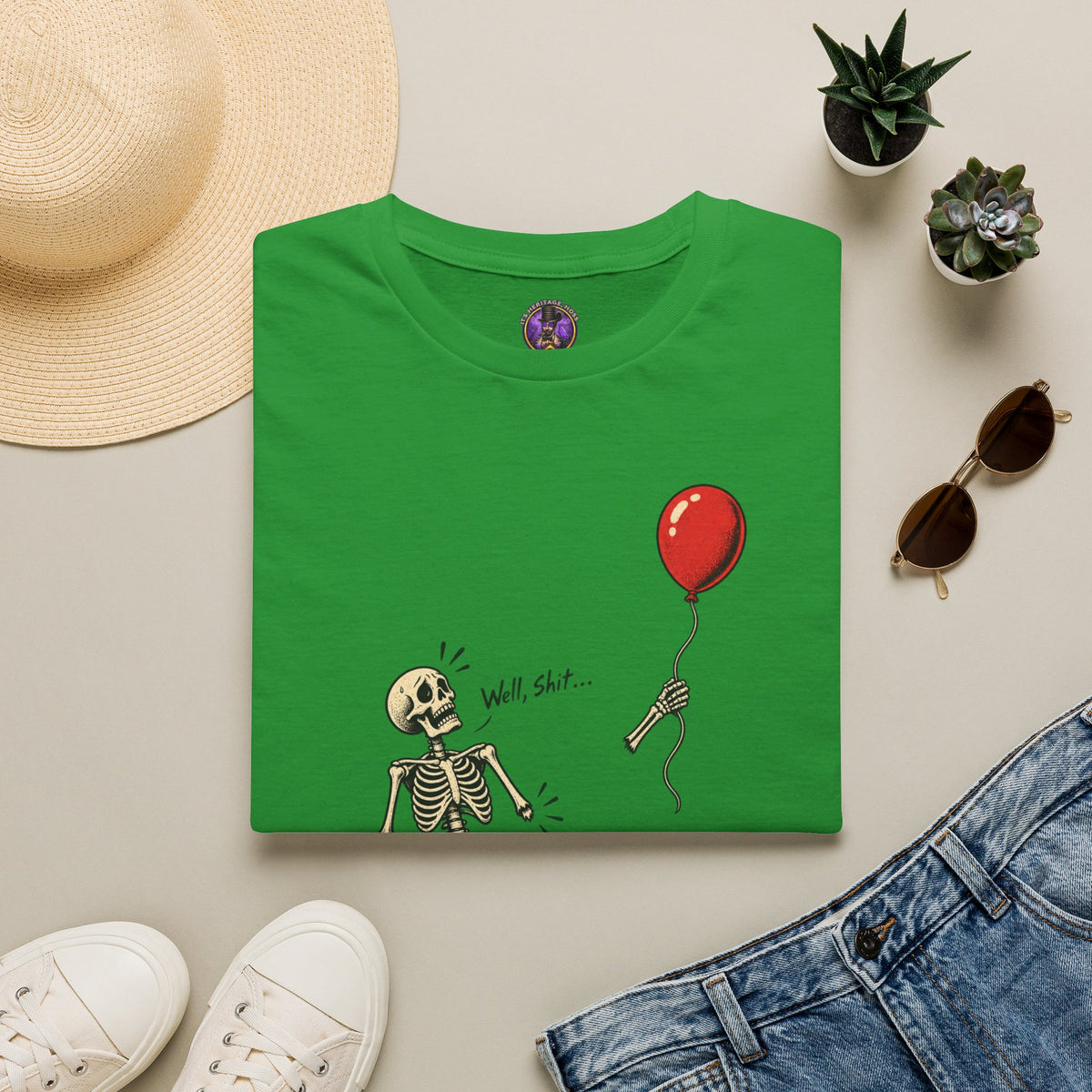 Well Shit Skeleton Balloon Halloween shirt laid flat with jeans and accessories.