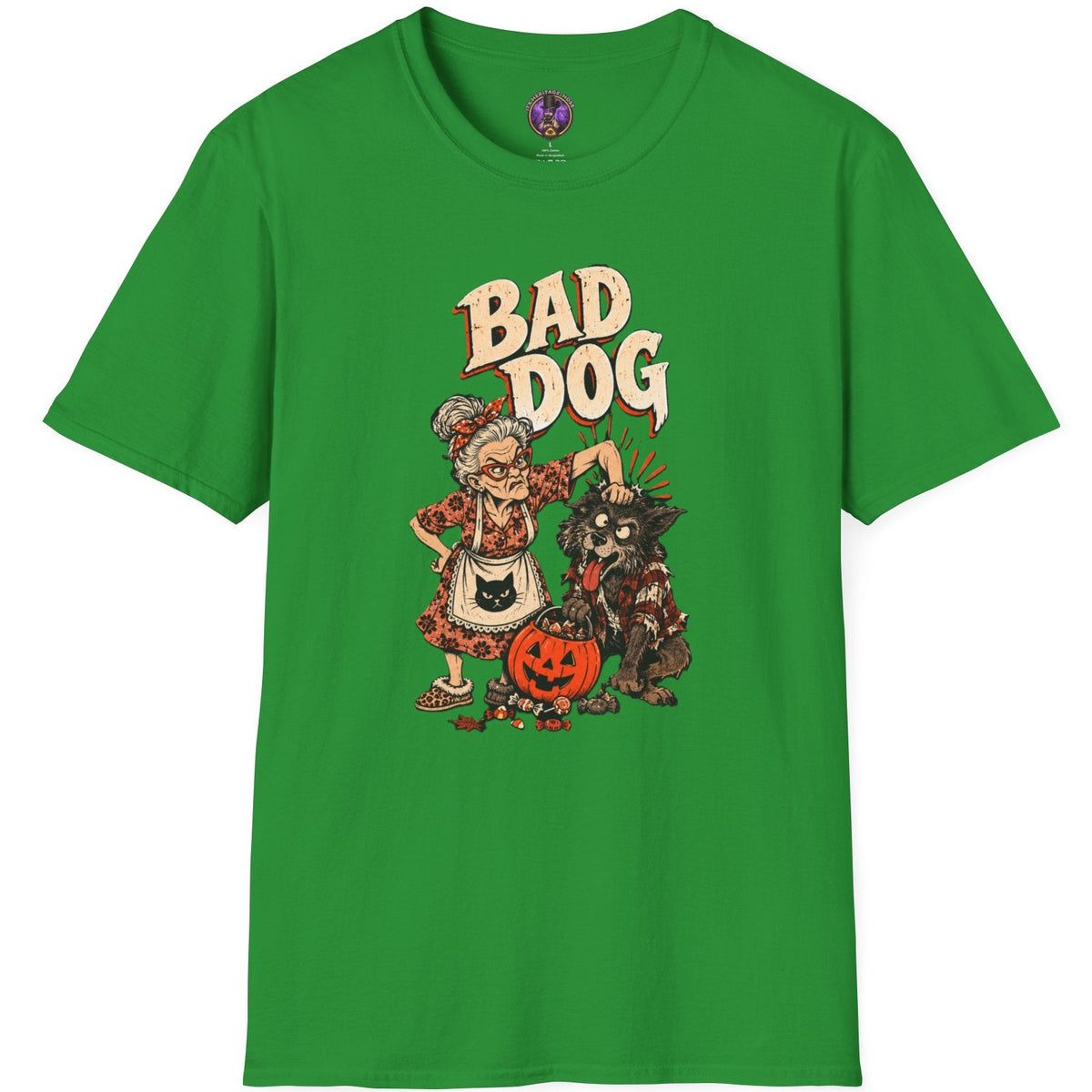 A bright green short-sleeve t-shirt with a graphic print on the front featuring a cartoon character dressed as a witch next to a black cat and a jack-o'-lantern, with the text 'BAD DOG' above them.