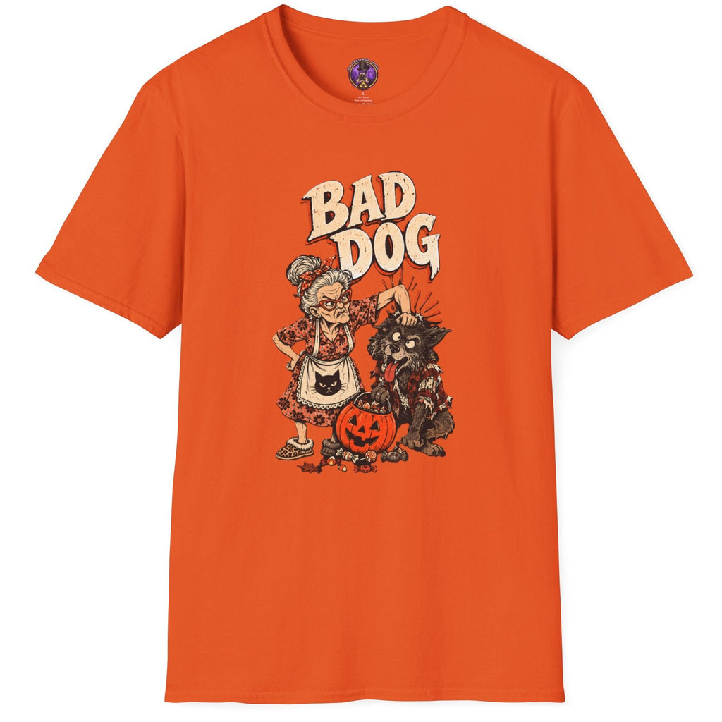 An orange short-sleeve crewneck t-shirt featuring a vintage-style graphic of a cartoon dog dressed in Halloween clothes next to a jack-o'-lantern, with the text 'BAD DOG' printed above.