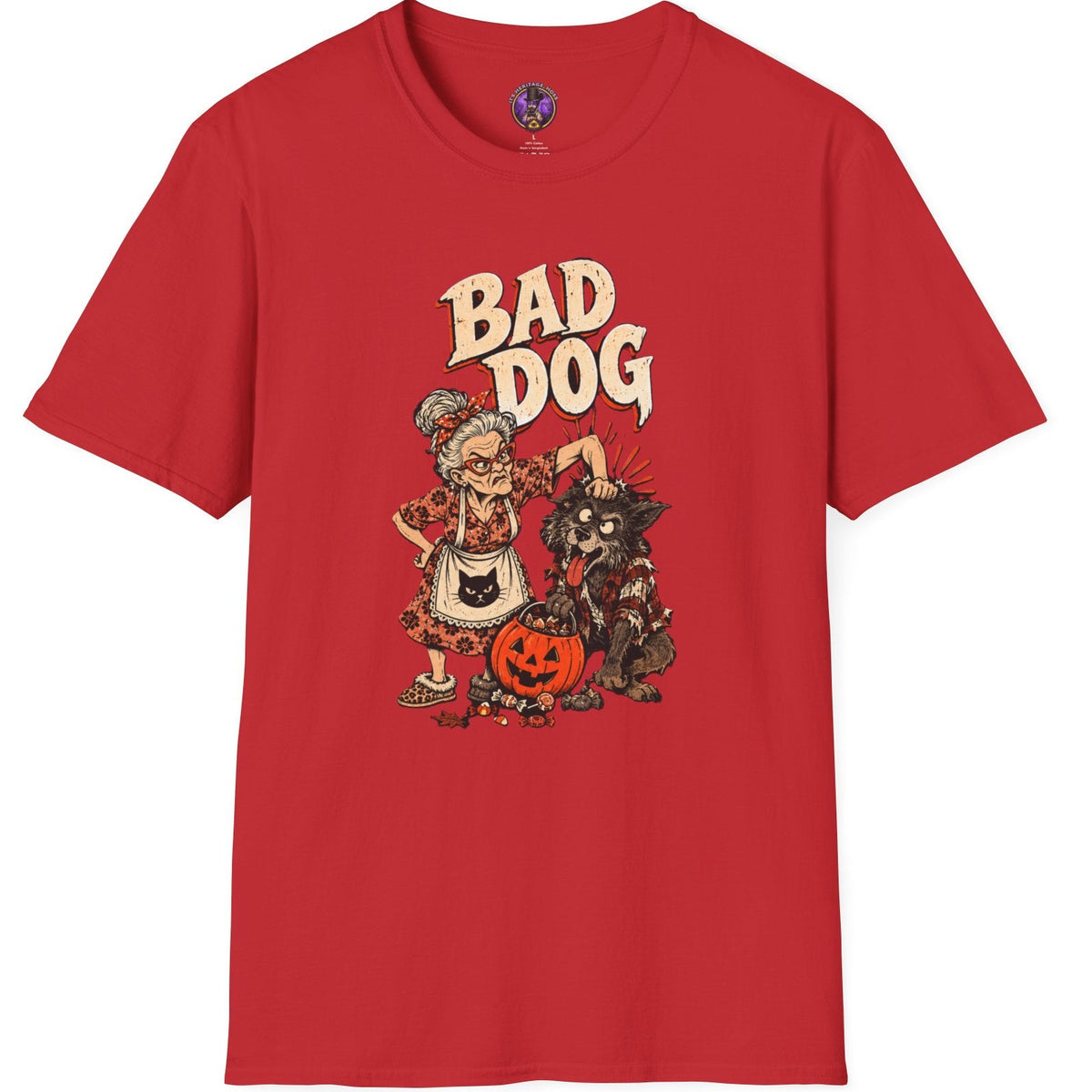 A red short-sleeve crewneck t-shirt featuring a cartoon graphic of a bad dog dressed in Halloween attire next to a jack-o'-lantern, with the text 'BAD DOG' printed above.
