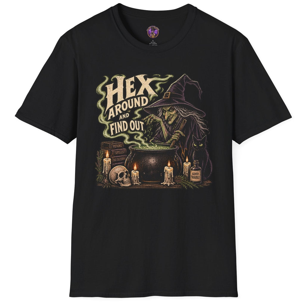 A black short-sleeve crewneck t-shirt featuring a gothic witch graphic on the front. The graphic depicts a witch in a pointed hat looking into a cauldron with the text 'HEX AROUND TO FIND OUT' in a stylized font, surrounded by candles, a skull, and potion bottles.